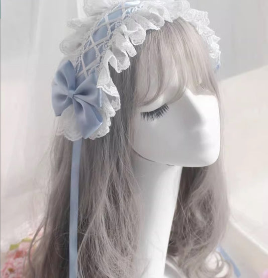 A head dress with an angelic look, made of lace and light blue satin, giving it a translucent feel like the sky of heaven.